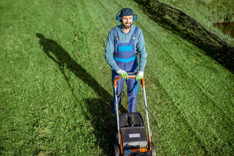 gardener-working-with-lawn-mower-on-the-backyard-2025-03-16-09-40-17-utc